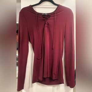 Burgundy Express long sleeve lace up shirt.